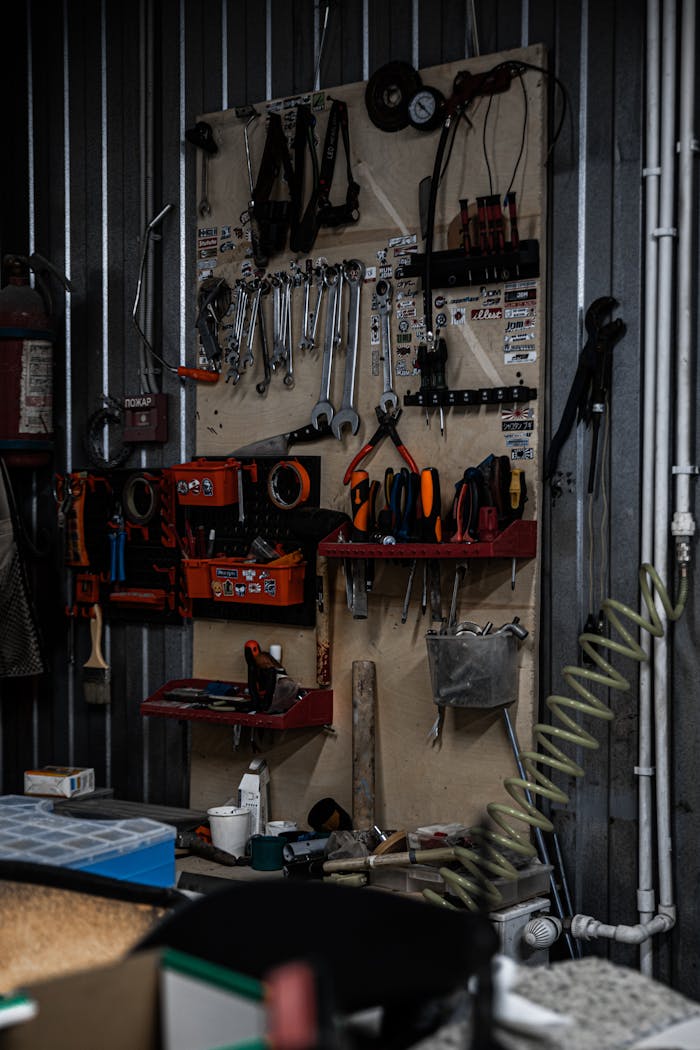 A detailed view of a well-organized garage workshop with various tools hanging and stored neatly.